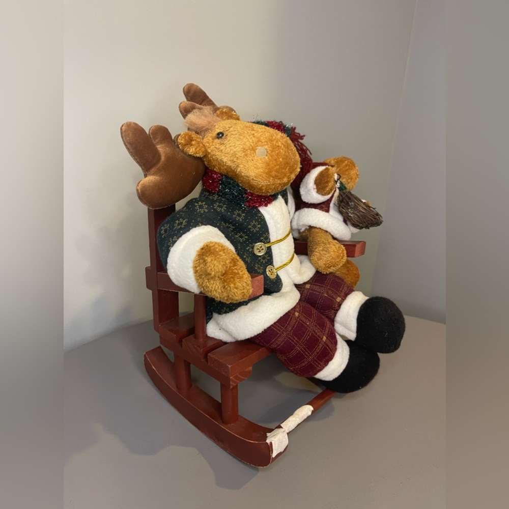 Reindeers in miniature wooden rocking chair, winter decor